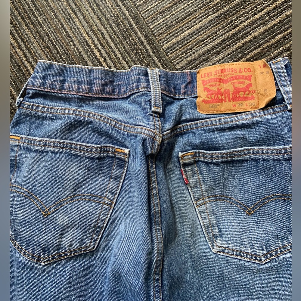 Slightly Distressed Levi’s Medium Wash Straight Leg denim Jeans